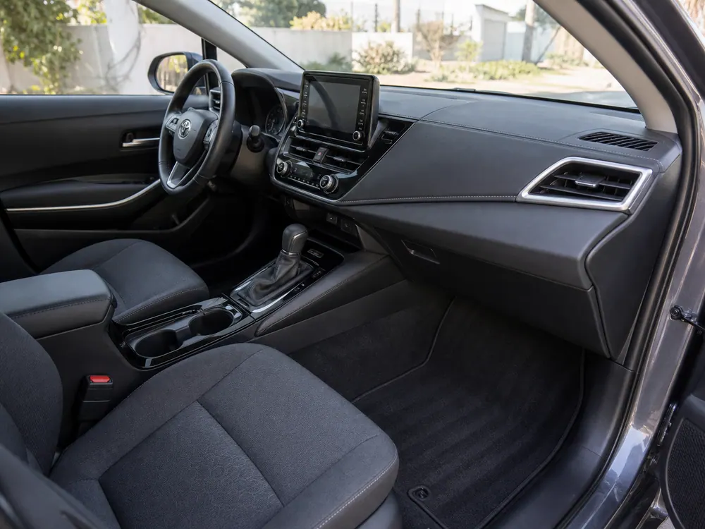 Clean car dashboard, seats, mats, and footwell after interior service.